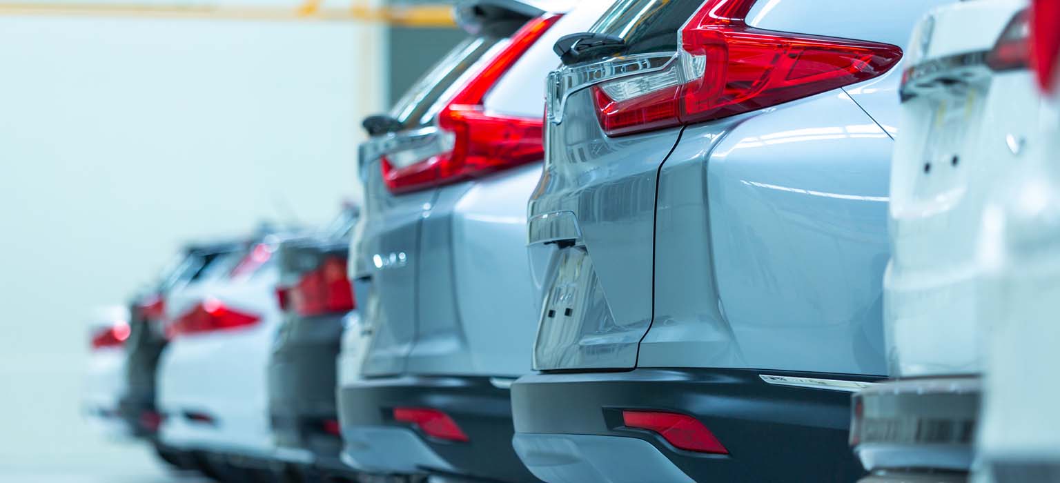 A row of cars in a parking lot